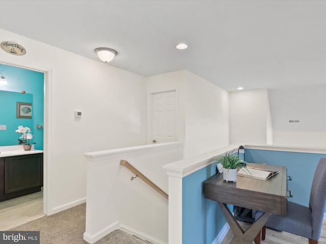 hallway featuring light carpet