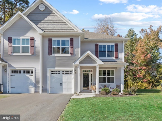 view of front of home with a front lawn and a garage