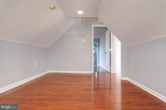 bonus room featuring wood-type flooring and vaulted ceiling