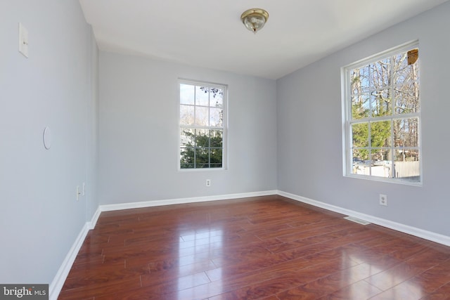 empty room featuring dark hardwood / wood-style flooring