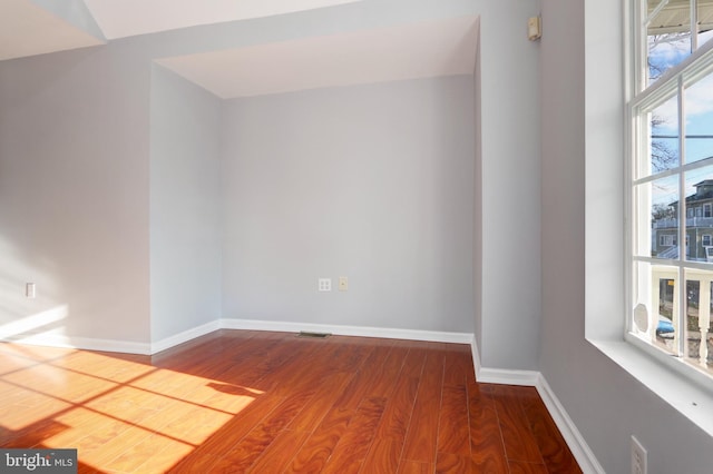 empty room with hardwood / wood-style flooring