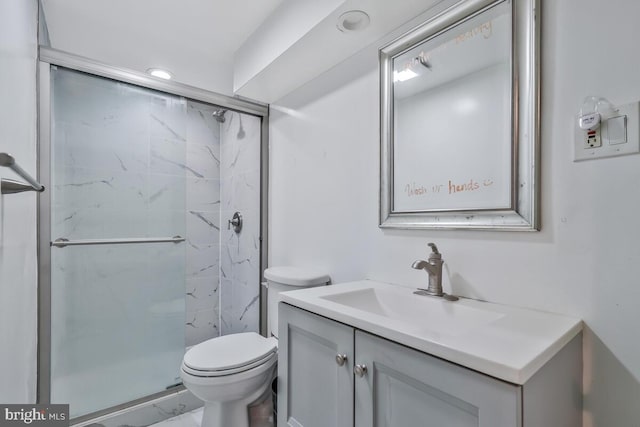 full bathroom featuring marble finish floor, toilet, vanity, and a marble finish shower
