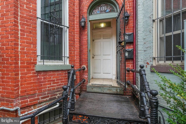 entrance to property with brick siding