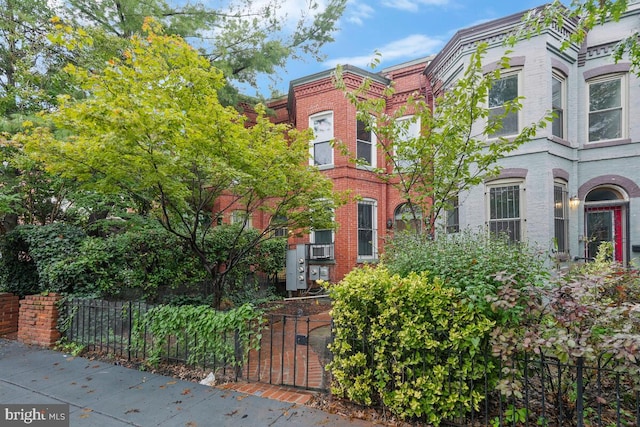 view of property with brick siding and fence private yard