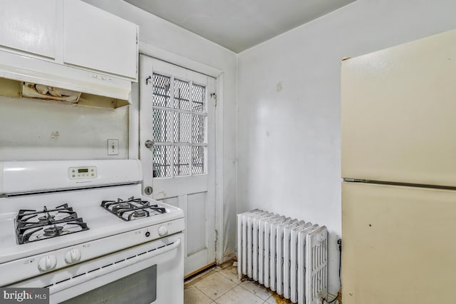 kitchen with white cabinetry, radiator heating unit, white appliances, and light tile patterned floors