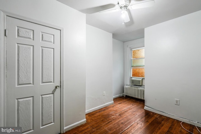 interior space featuring radiator, ceiling fan, dark wood-type flooring, and cooling unit