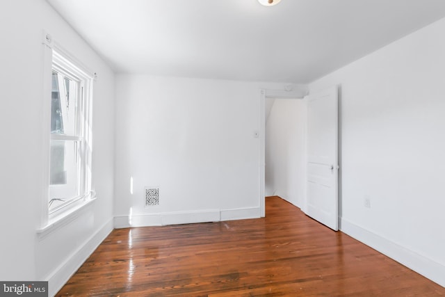 empty room featuring dark hardwood / wood-style flooring