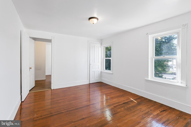 empty room with dark wood-type flooring