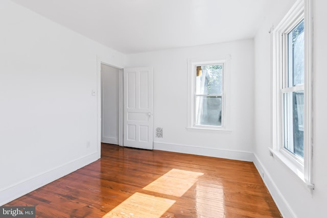 empty room featuring dark hardwood / wood-style flooring