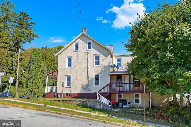 back of property with covered porch