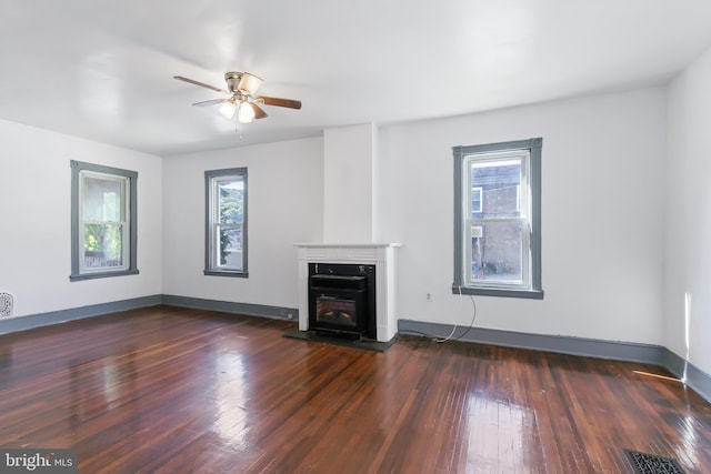 unfurnished living room featuring dark hardwood / wood-style floors and ceiling fan