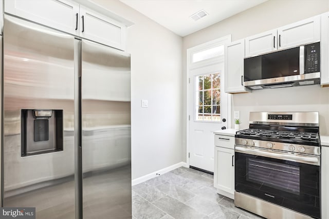 kitchen with appliances with stainless steel finishes and white cabinetry