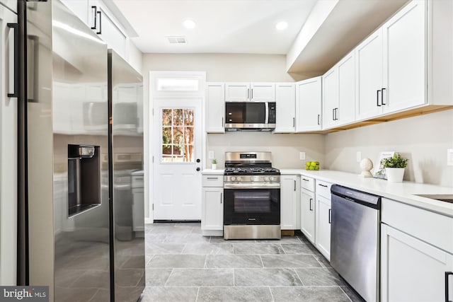 kitchen with appliances with stainless steel finishes and white cabinetry