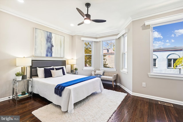 bedroom featuring crown molding, dark wood-type flooring, and ceiling fan