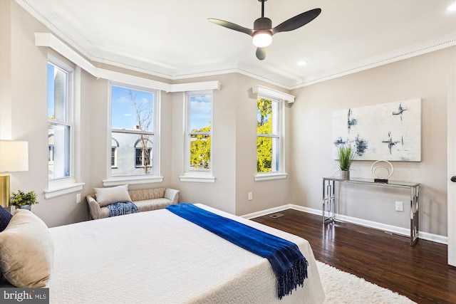 bedroom with dark wood-type flooring, ceiling fan, and ornamental molding