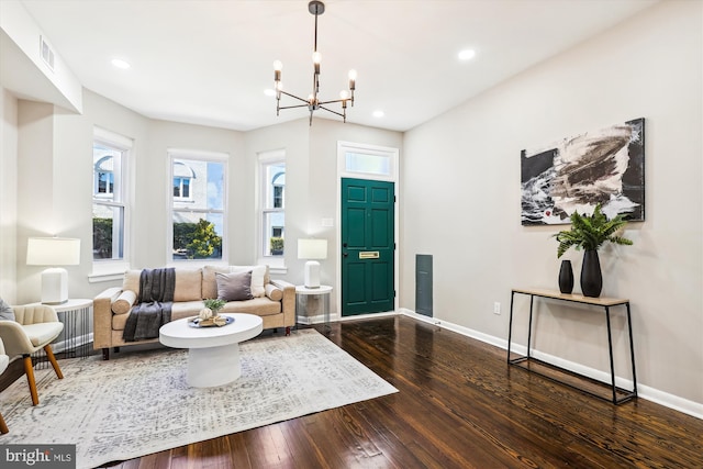 living room featuring wood-type flooring and a chandelier