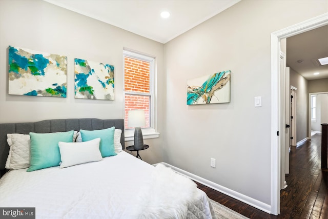 bedroom with dark hardwood / wood-style floors