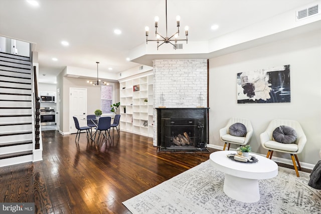 living room featuring dark wood-type flooring and a fireplace