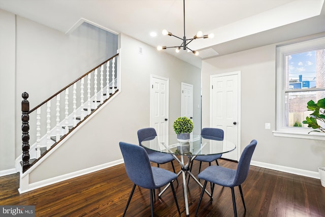 dining space featuring a notable chandelier and dark hardwood / wood-style floors