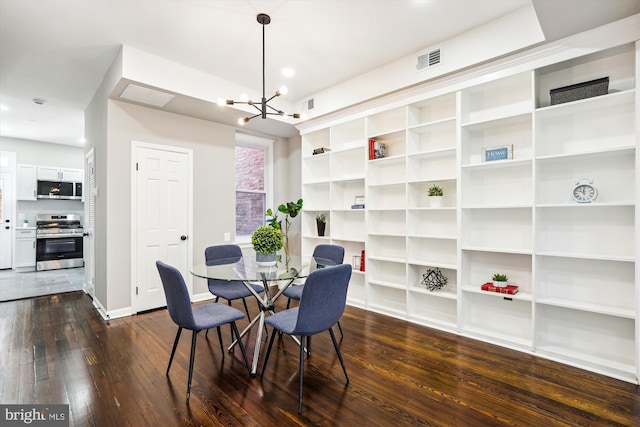 dining space with a notable chandelier and dark hardwood / wood-style flooring