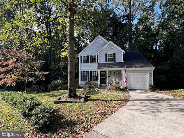 front of property with a porch and a garage