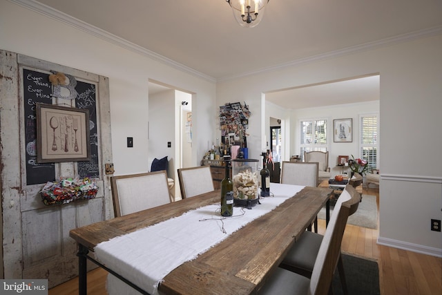 dining space featuring ornamental molding and wood-type flooring