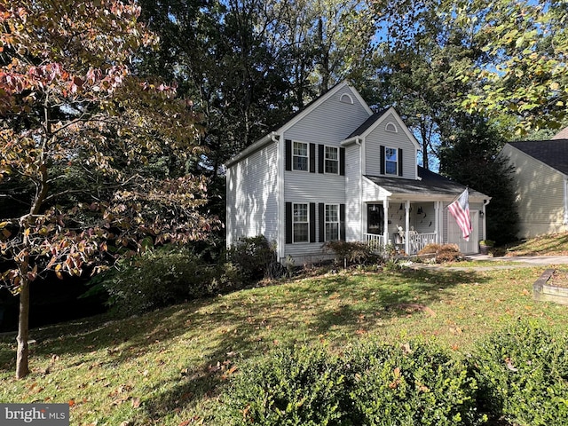 front facade with covered porch and a front yard