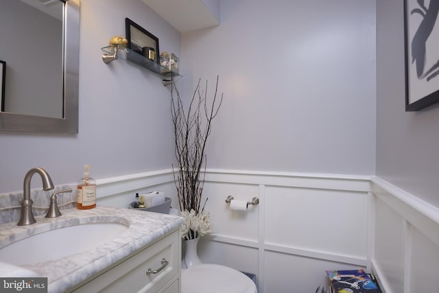 bathroom featuring toilet and vanity