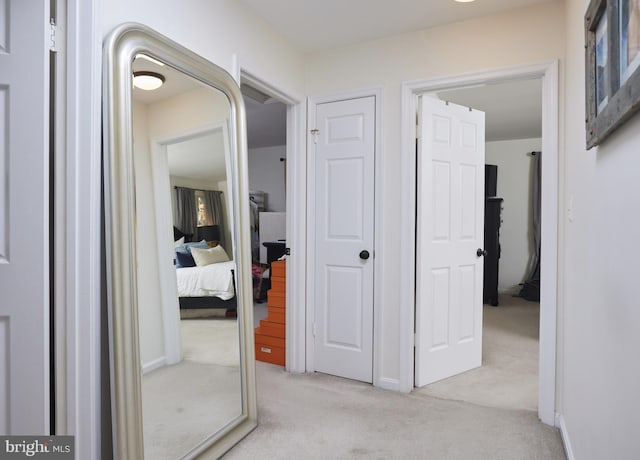 corridor featuring light colored carpet