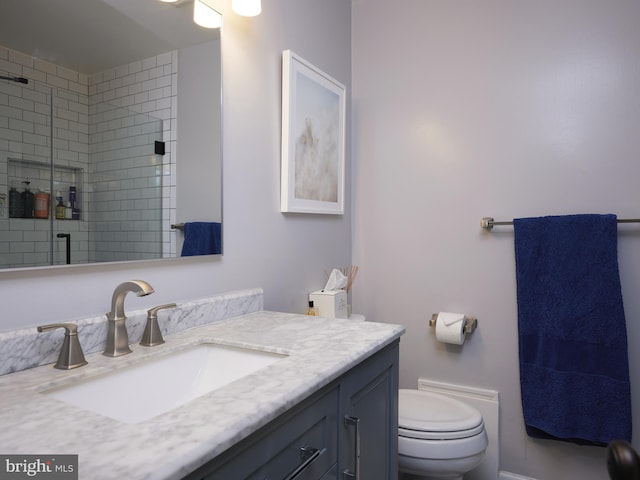 bathroom with vanity, toilet, and an enclosed shower