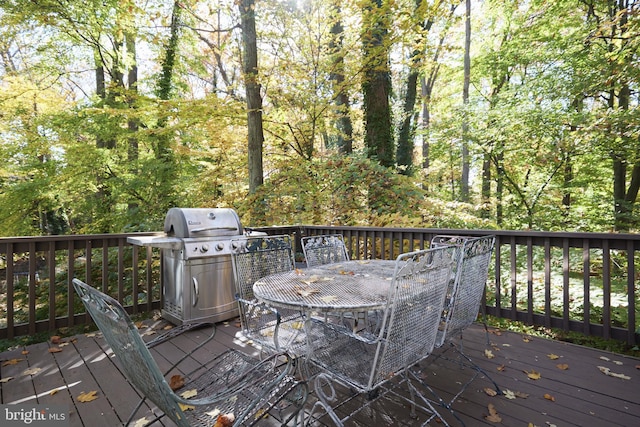 wooden deck featuring a grill