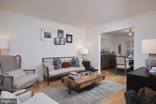 living room featuring light hardwood / wood-style flooring and crown molding