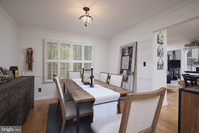 dining area with crown molding and wood-type flooring