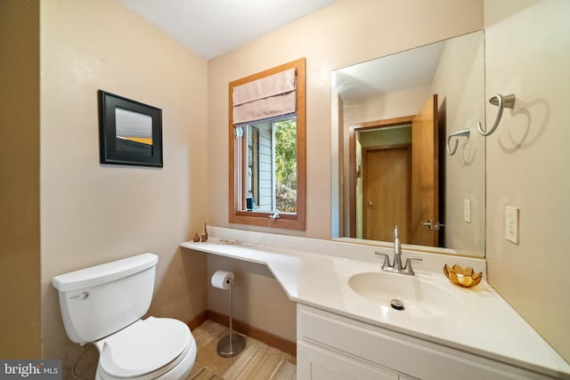 bathroom featuring vanity, toilet, and tile patterned flooring