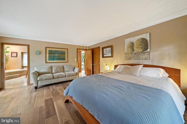 bedroom featuring ornamental molding and wood-type flooring