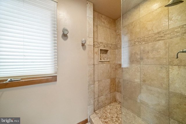 bathroom with tiled shower