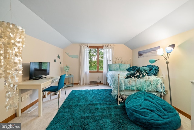 bedroom with vaulted ceiling and carpet floors