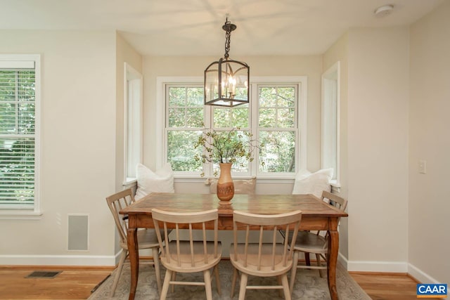 dining space featuring a chandelier and hardwood / wood-style flooring