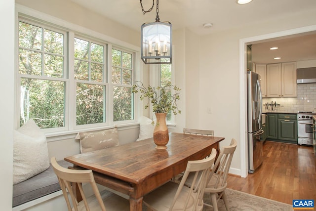 dining room featuring a notable chandelier and dark hardwood / wood-style floors