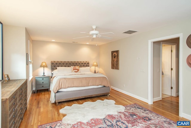 bedroom with light hardwood / wood-style floors and ceiling fan