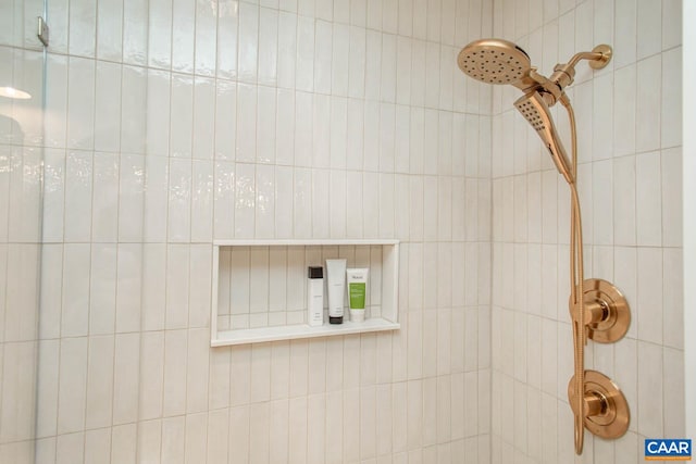 interior details featuring a tile shower