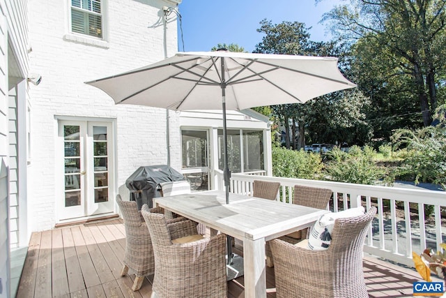 wooden terrace featuring french doors and a grill