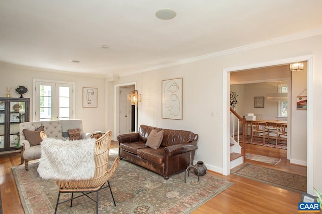 living room with ornamental molding and hardwood / wood-style floors