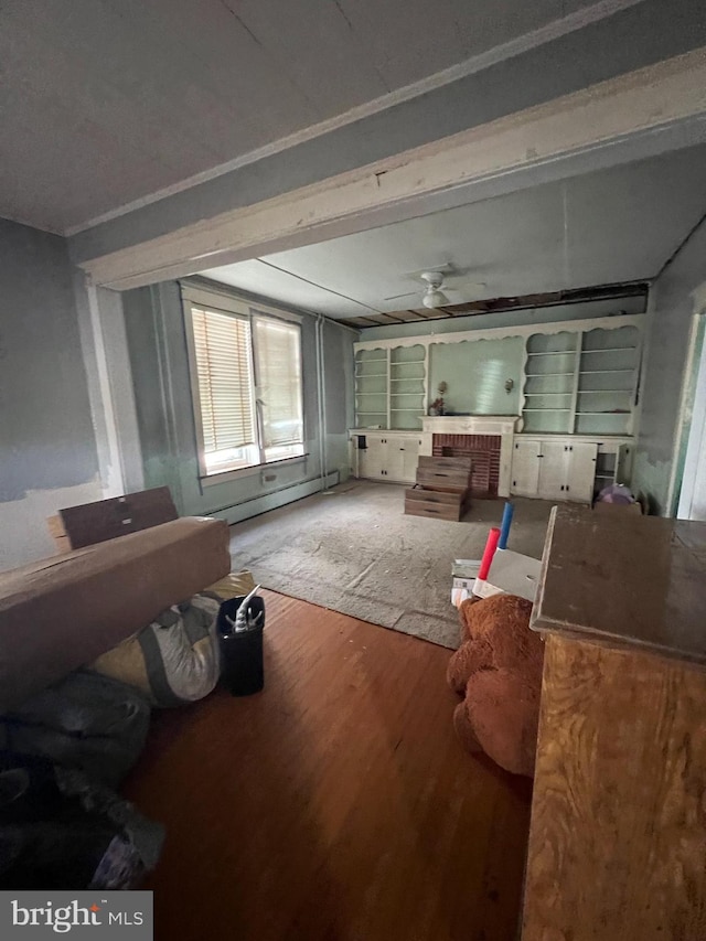 misc room featuring ceiling fan, ornamental molding, a baseboard radiator, and hardwood / wood-style floors