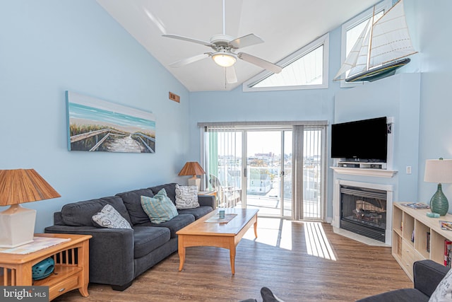 living room featuring hardwood / wood-style flooring, high vaulted ceiling, and ceiling fan