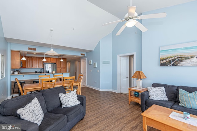 living room with ceiling fan, high vaulted ceiling, and dark hardwood / wood-style flooring