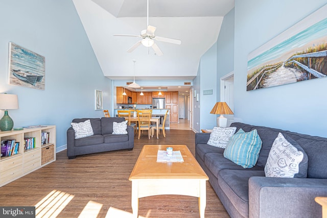 living room with high vaulted ceiling, dark wood-type flooring, and ceiling fan