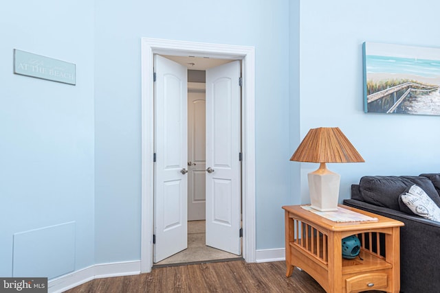 corridor featuring dark wood-type flooring