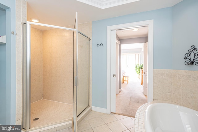 bathroom featuring tile patterned floors and shower with separate bathtub