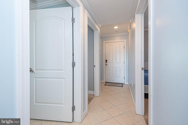 corridor featuring crown molding and light tile patterned flooring